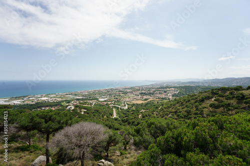 Panoramic view of Barcelona and the Maresme. Made from Premia de Dalt. Sunny day with some decorative clouds.