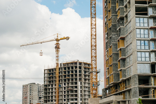 Construction site background. Hoisting cranes and new multi-storey buildings. I.ndustrial background.