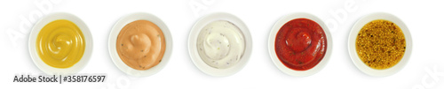 Collection of various sauces in white ceramic bowl top view. Mustard, burger sauce, tartar, ketchup isolated on white background. 