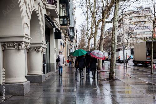 The famous Serrano street on a rainy winter day at Madrid city center in Spain