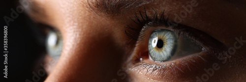 Amazing female green colored eyes in low light technique