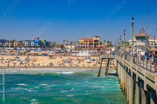 View of the pier, ocean and beach in surf city Huntington Beach, famous tourist destination in California