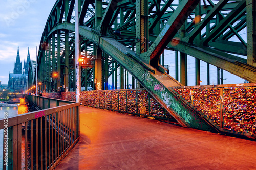 Cathedral and illuminated Hohenzollern bridge in Cologne, Germany