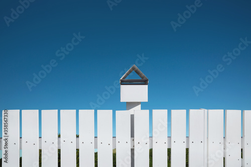 White fences with mailbox and blue sky, Clipping path.