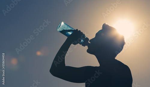 Young man drinking water. 