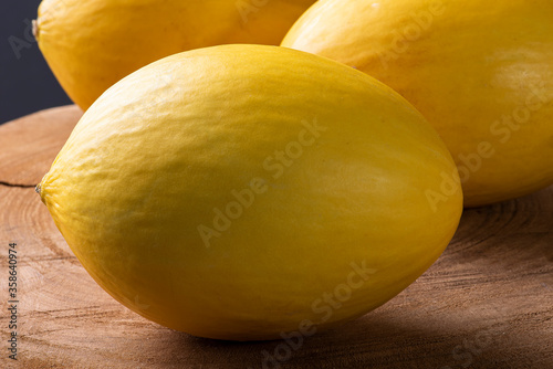 .Whole yellow melon on wooden background