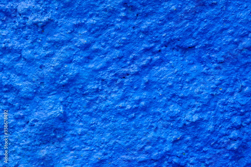 Rough blue cement wall surface. This image is suitable for use as wallpaper or background. Sandy surface.