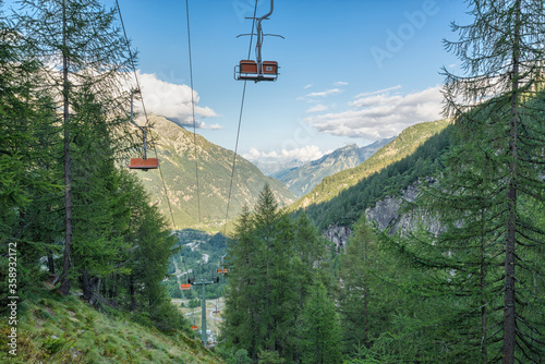 Chair lift on the european alps in summer. Vacation and hiking concept. Macugnaga and the Anzasca valley view from the Belvedere , Piedmont, Italy