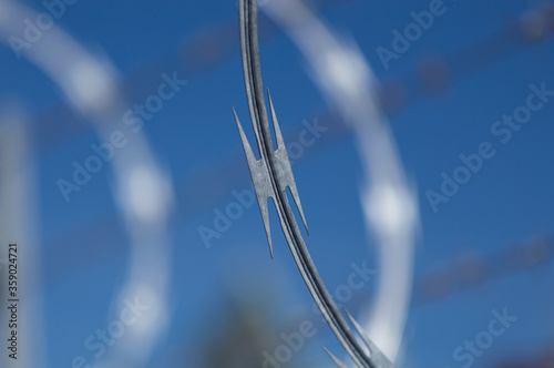 Razor concertina wire against blue sky