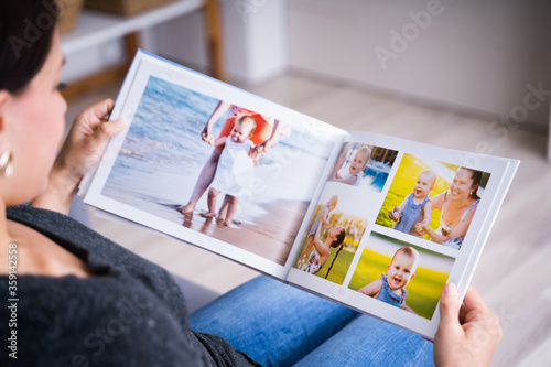 Woman Looking At Photo Album