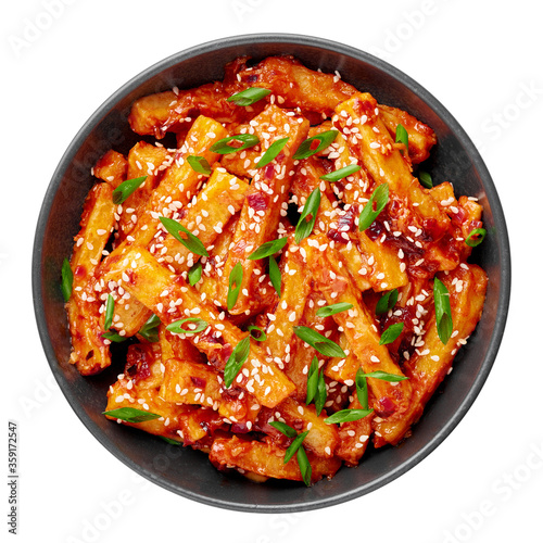 Honey Chilli Potato or Schezwan Aloo in black bowl isolated on white backdrop. Chilli Potatoes is indo-chinese cuisine dish. Authentic asian food. Indian meal. Top view.