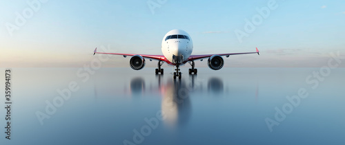 Airplane on runway at sunset. Passenger aircraft, commercial airline.