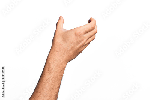 Hand of caucasian young man showing fingers over isolated white background holding invisible object, empty hand doing clipping and grabbing gesture