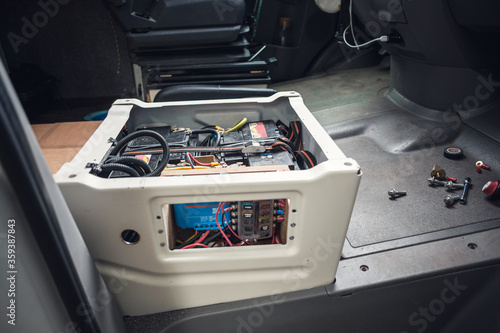 Electronics build into the front seat of a camper van