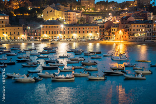 Breathtaking view of the bay with boats and yachts. Warm summer evening in the resort town. Romantic vacation. Italy, Sestri Levante, Bay of Silence