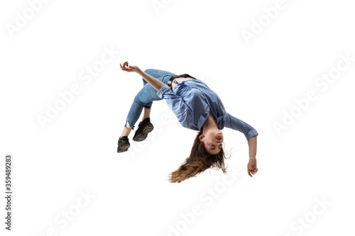 Mid-air beauty cought in moment. Full length shot of attractive young woman hovering in air and keeping eyes closed. Levitating in free falling, lack of gravity. Freedom, emotions, artwork concept.