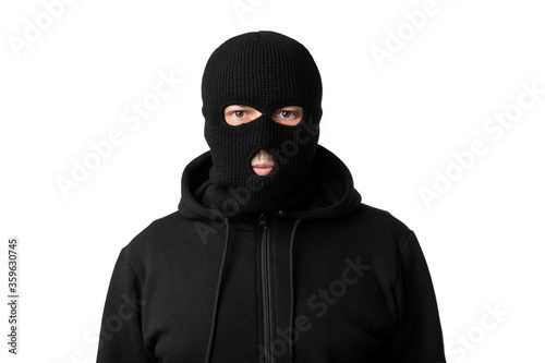 Portrait of masked thief isolated over white studio wall