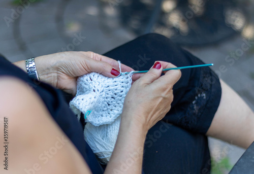 Woman knitting with yarn 