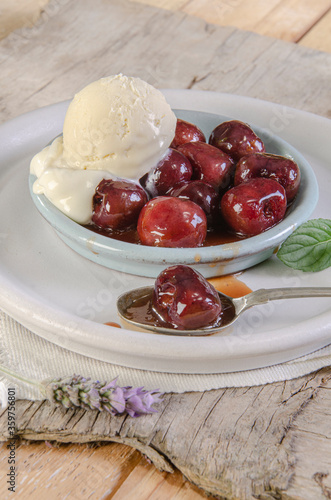 A nice bowl of cherries jubilee with scoop of vanilla ice cream Sumptuous dessert