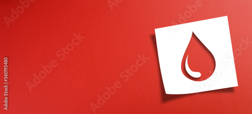 Note paper with blood donation concept on red background