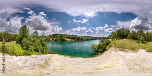 full seamless spherical hdri panorama 360 degrees angle view on limestone coast of huge green lake or river near forest in summer day with beautiful clouds in equirectangular projection, VR content