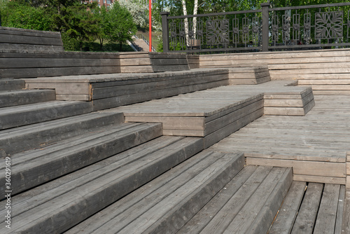 A multi-tiered wooden amphitheater near the riverbank.