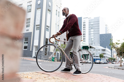 African American man sitting on his bike in the city street