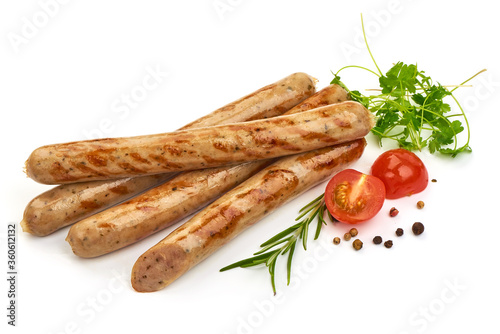 Grilled German White Thin sausages with herbs, pepper and tomatoes, isolated on a white background. Close-up.