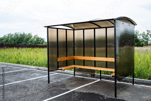 bus stop in a rural village, made of brown polycarbonate, outdoors