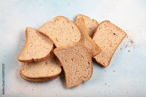 Macrophotography of green mildew on a stale bread. Surface of moldy bread. Spoiled bread with mold. Moldy fungus on rotten bread.