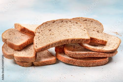 Macrophotography of green mildew on a stale bread. Surface of moldy bread. Spoiled bread with mold. Moldy fungus on rotten bread.