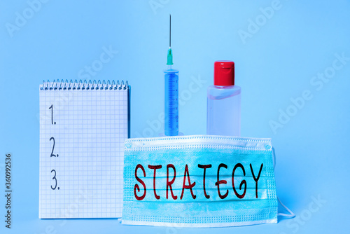 Conceptual hand writing showing Strategy. Concept meaning action plan or strategy designed to achieve an overall goal Set of medical equipment with notepad for health assessment