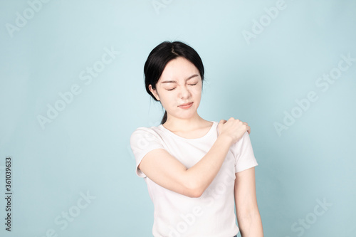 A young chinese woman in front of blue background