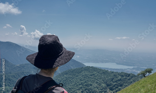 woman or girl looking the Landscape of Lake Como from an alpine trail.