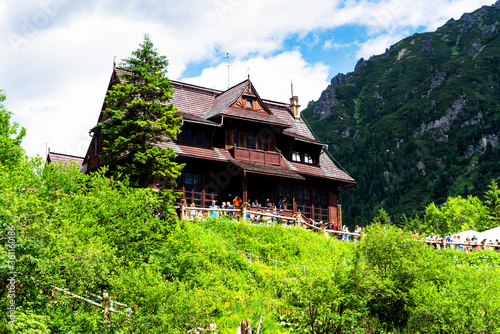 MORSKIE OKO, POLAND - JULY 6, 2019: Mountain shelter house in Tatra Mountains, Morskie Oko Lake, Poland. Tatra Mountains is very popular travel destination.