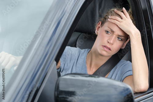 impatient female car driver stuck in traffic