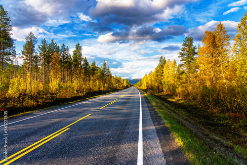 Scenic asphalt road through the beautiful view of mountain in lofoten island, Norway during autumn. Concept of roadtrip, travel, vacation, adventure.