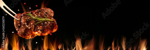 Beef steak falling on the grill with fire. Brazilian barbecue