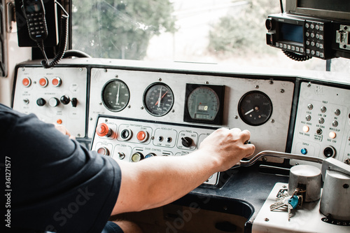 A comeng electric train in Melbourne australia, inside controls being driven by a train driver