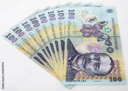 Many 100 RON or lei romanian banknotes on white background. Romanian currency.