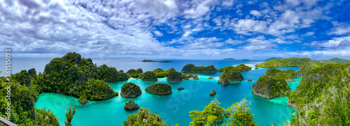 A beautiful lagoon is surrounded by limestone islands in Raja Ampat, West Papua, Indonesia.