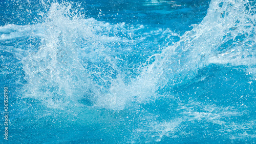 Blue water splash in the pool