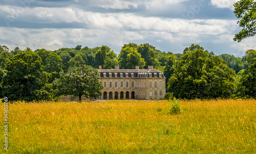 A view across the fields towards the ruins of Boughton House near Geddington, UK in summer