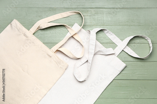Eco bags on wooden background