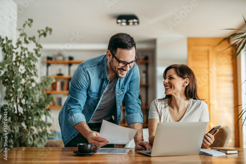 Portrait of successful smiling small business owners at cozy office.