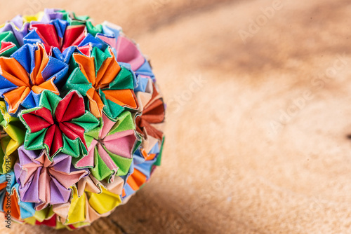 Colorful handmade origami keychain on a wooden background