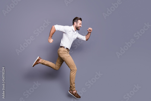 Full length body size view of his he nice attractive glad cheerful cheery man jumping running sprint distance marathon motivation isolated over grey violet purple pastel color background