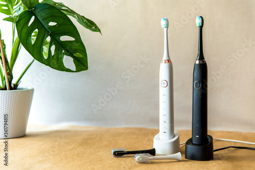 Modern black and white sonic or electric whitening toothbrush set. Concept of professional oral care and healthy teeth by using sonic smart toothbrush