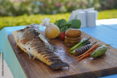 serving fish with vegetables and lemon
