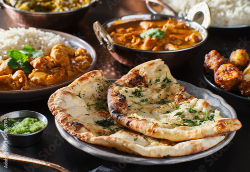 indian naan bread with herbs and garlic seasoning on plate